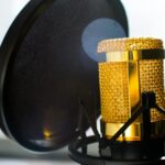 close up photo of gold colored and black condenser microphone